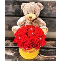 Teddy bear and flower arrangement